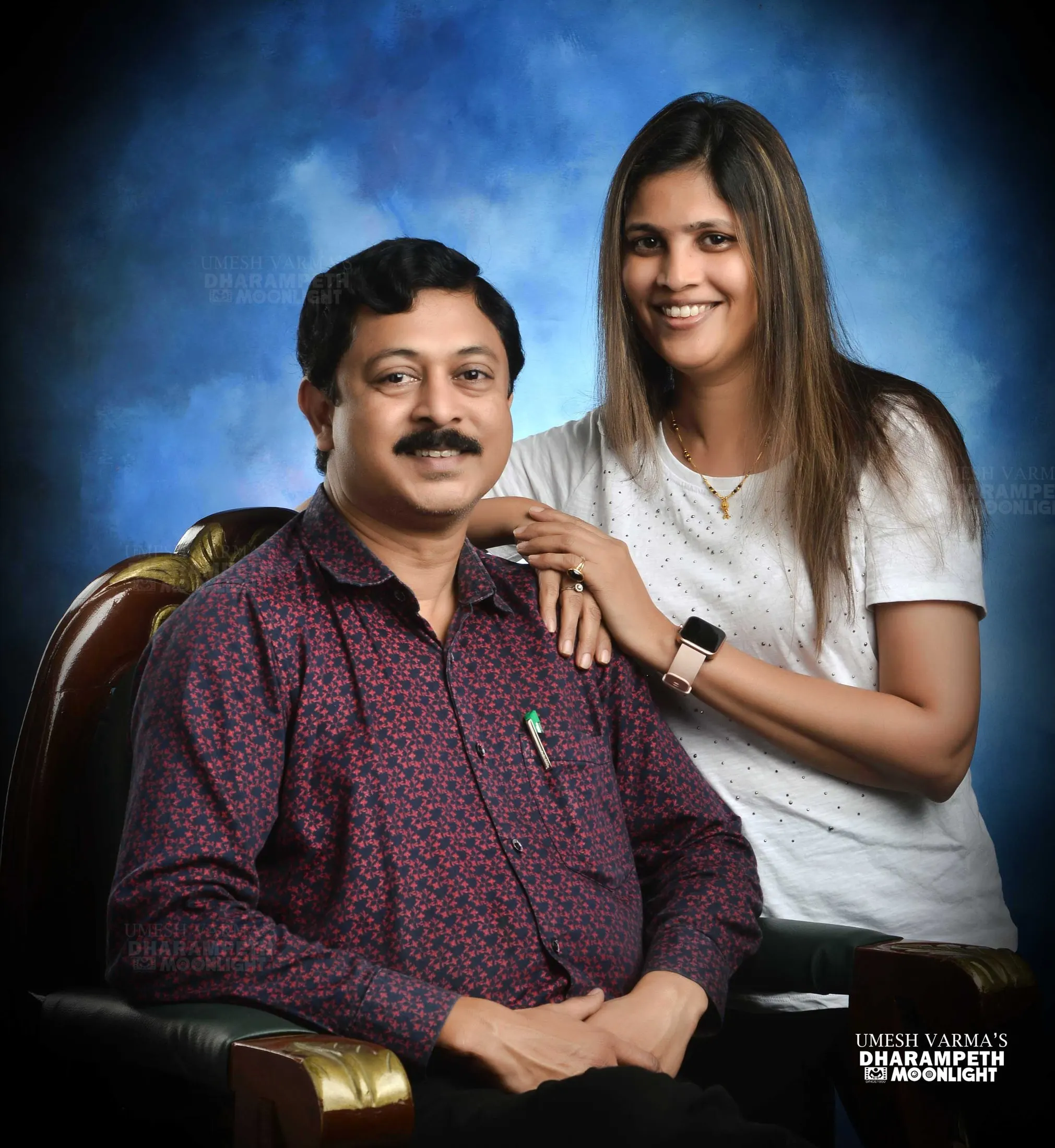 Couple with the husband seated in a carved chair
