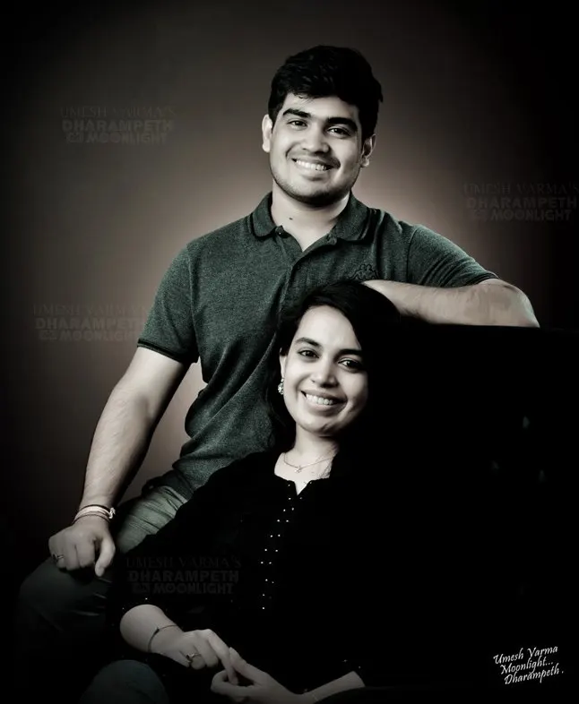 Black and white portrait of a couple, the wife seated in front
