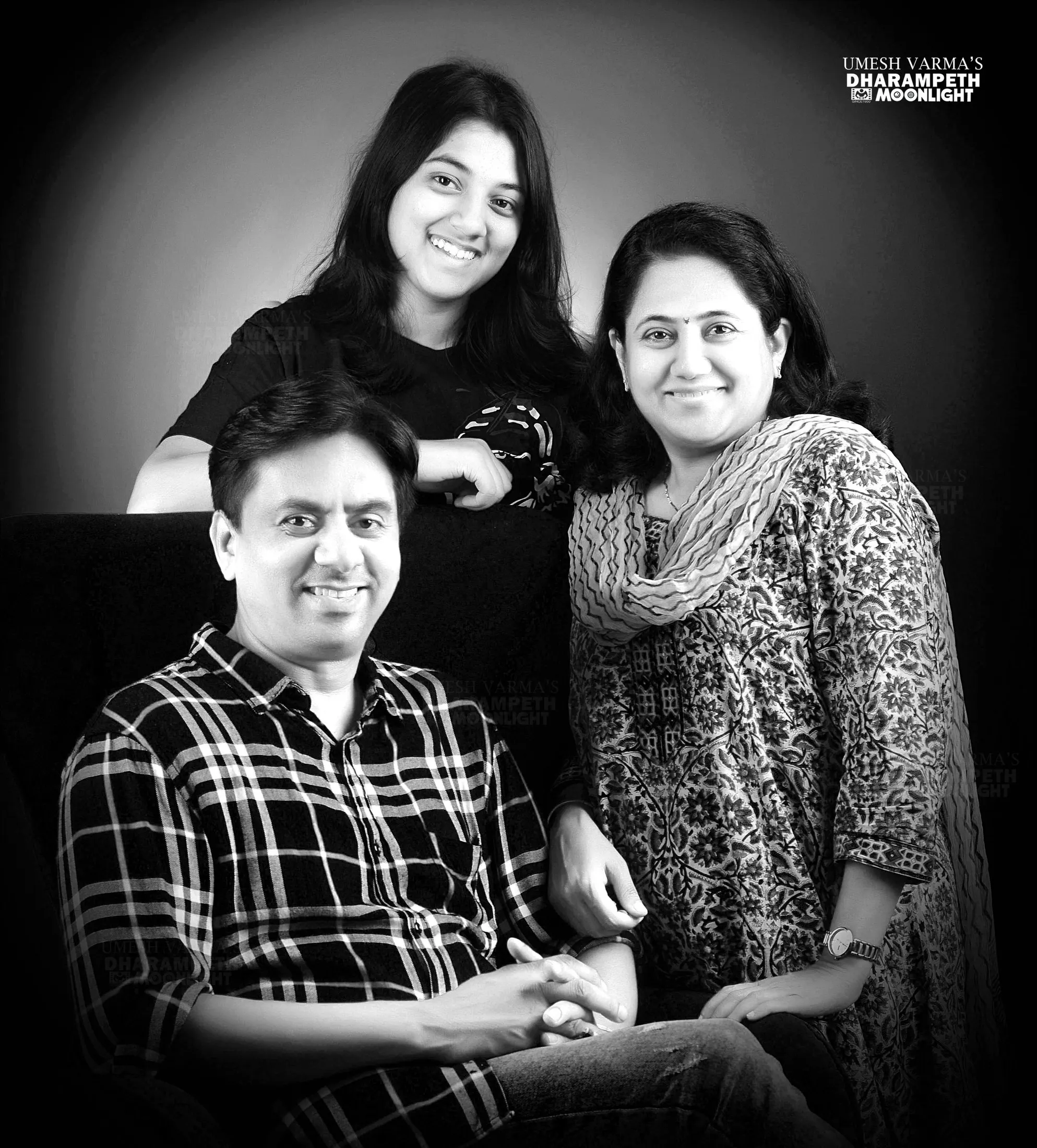 Black and white portrait of parents with their daughter