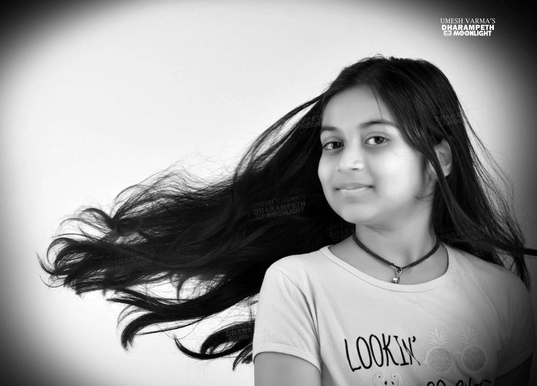 Black and white portrait of a girl with her hair in motion