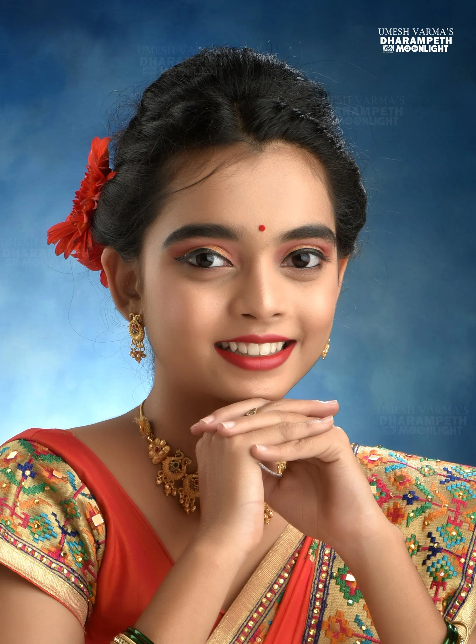 Girl in a traditional outfit with a red flower in her hair