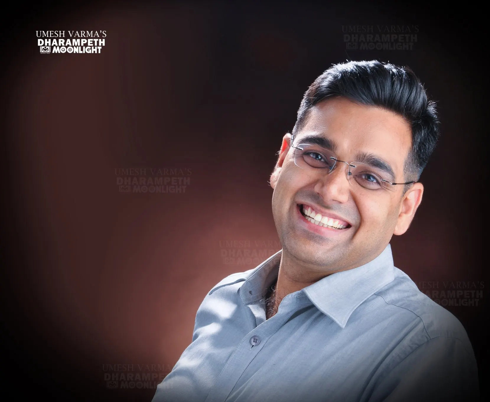 Profile headshot of a smiling man in glasses