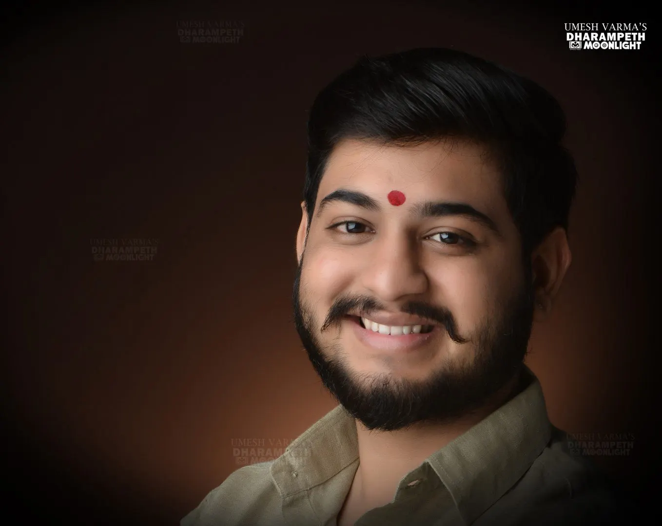 Warm portrait of a smiling young man with a tilak