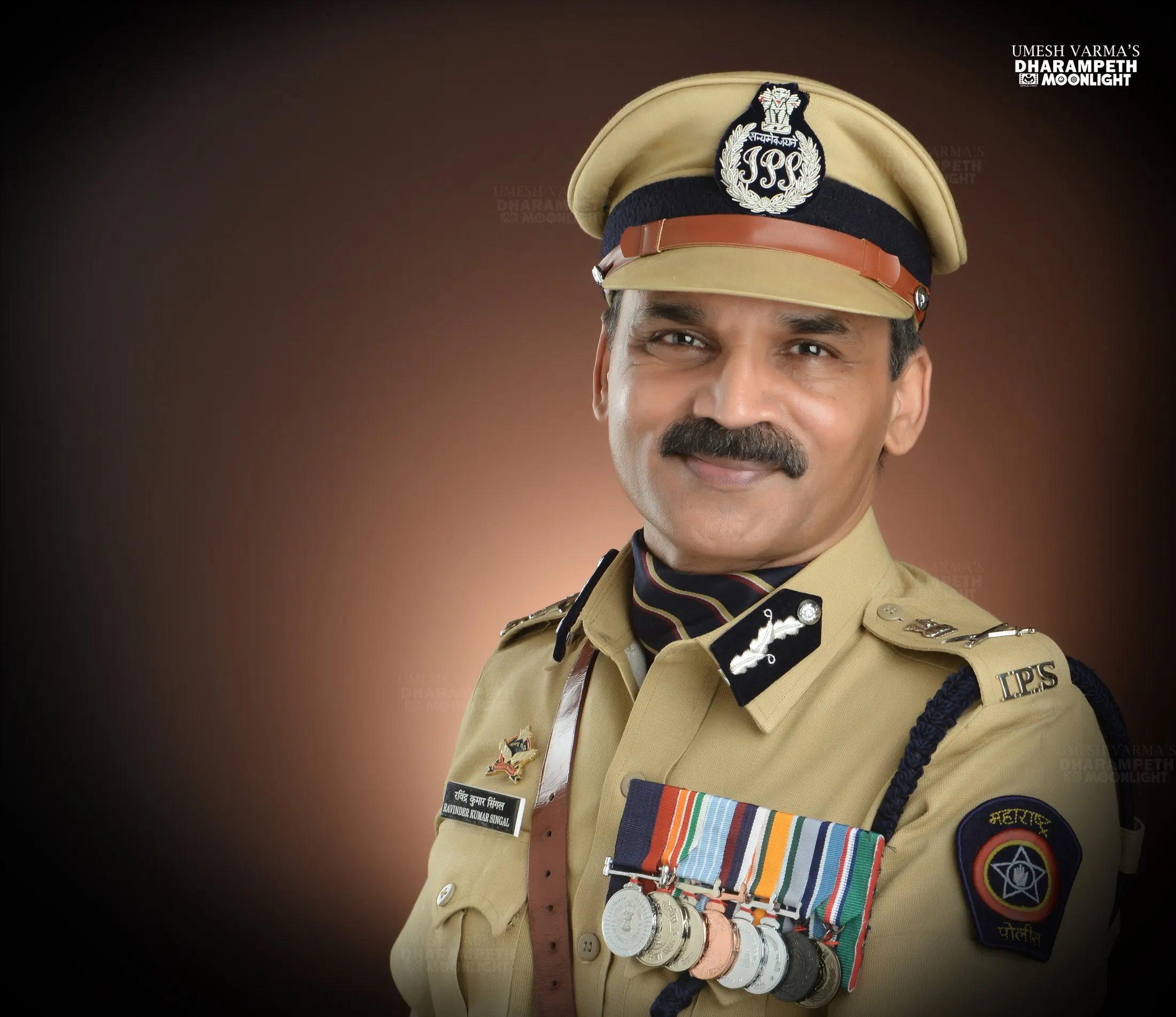 Formal portrait of an IPS officer in uniform with medals