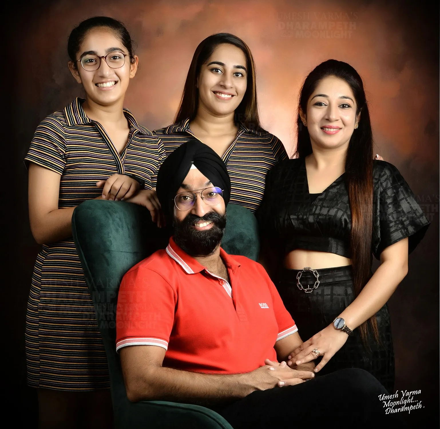 Family of four with the father seated in front