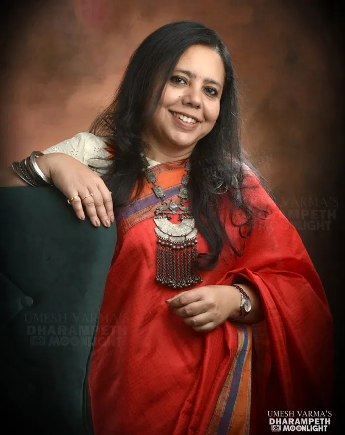 Woman in a red saree with a statement necklace